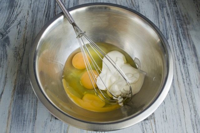 Пока разогревается духовка, смешиваем яйцо со сметаной