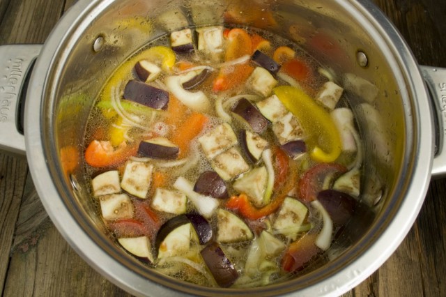 Складываем овощи в кастрюлю, добавляем баранину и заливаем бульоном