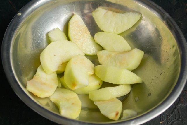 Нарезаем яблоко ломтиками, выжимаем сок из половинки лимона