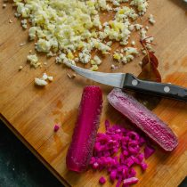 Маринованные огурцы режем очень маленькими кубиками