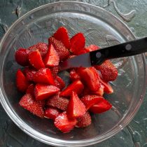 Нарезаем подготовленную клубнику: разрезаем небольшие ягоды пополам