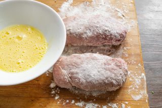 Панируем рулетики: сначала обваливаем в муке, затем во взбитом яйце и сухарях; при желании повторяем яйцо и сухари, чтобы панировка была плотнее.